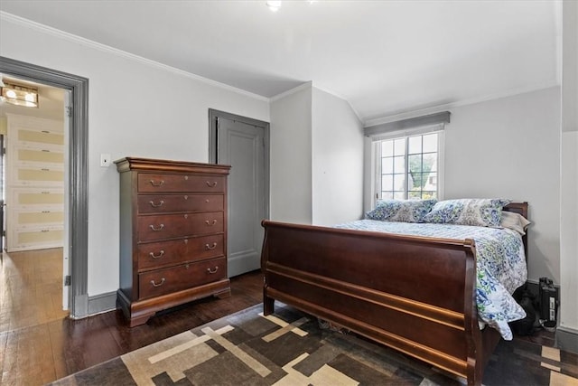 bedroom featuring dark wood-style floors, baseboards, and ornamental molding