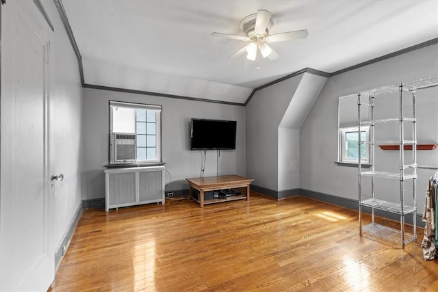 bonus room featuring radiator, vaulted ceiling, ceiling fan, light wood-type flooring, and baseboards