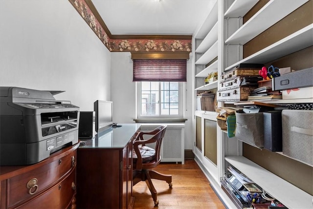 home office featuring light wood finished floors and ornamental molding