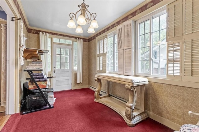 interior space featuring baseboards, ornamental molding, wallpapered walls, carpet, and an inviting chandelier