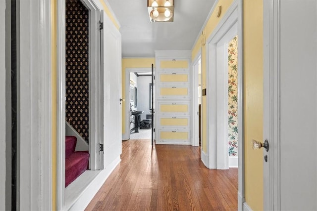 hallway with stairs, baseboards, and wood finished floors