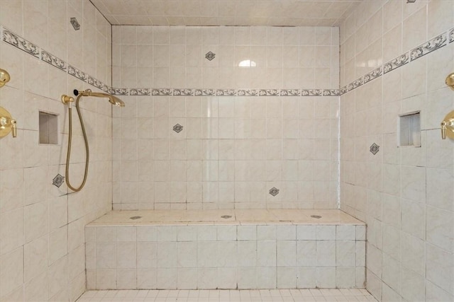 bathroom with a tile shower