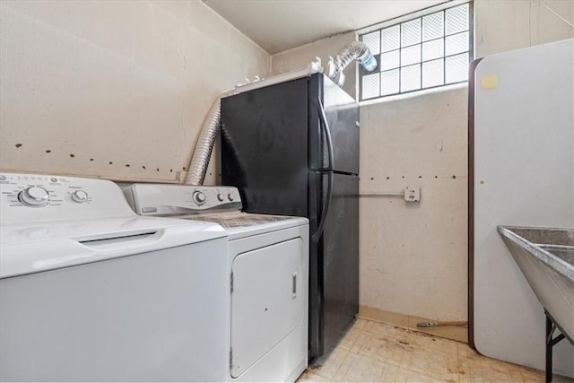 laundry room featuring laundry area, light floors, and separate washer and dryer