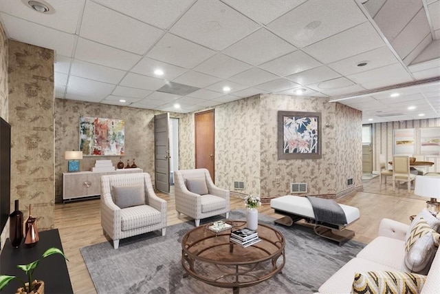 living room featuring wallpapered walls, visible vents, wood finished floors, and recessed lighting