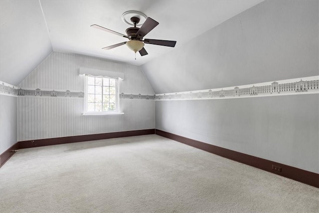 additional living space with lofted ceiling, ceiling fan, carpet flooring, and baseboards