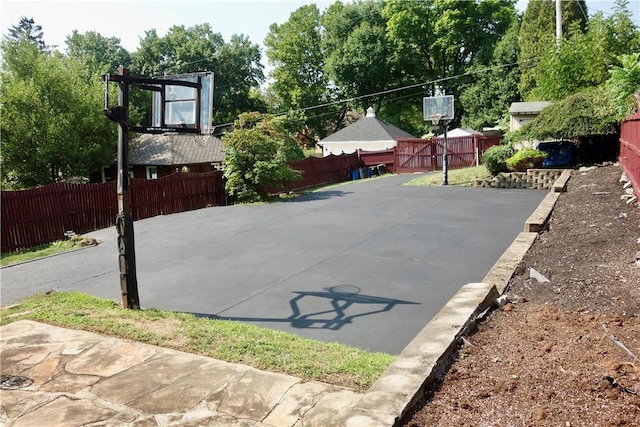 view of basketball court featuring fence and basketball court