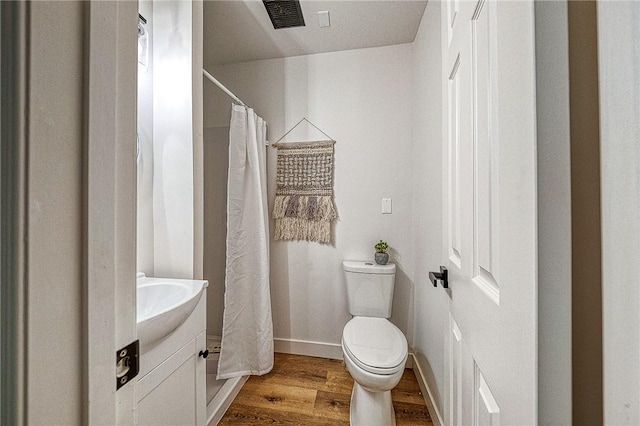 bathroom with vanity, hardwood / wood-style flooring, and toilet