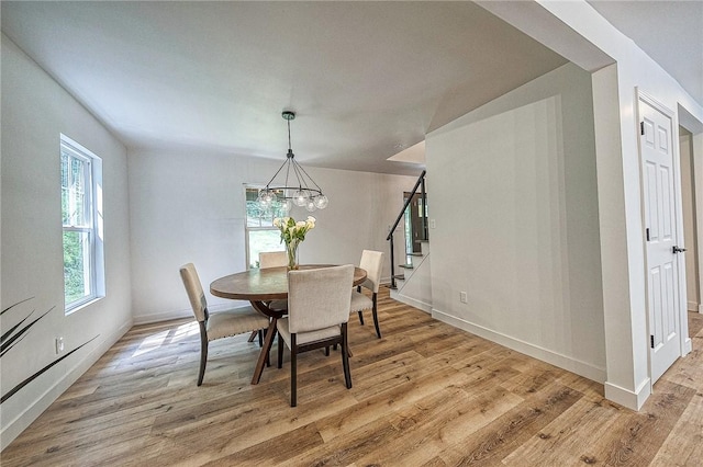 dining room featuring an inviting chandelier and light hardwood / wood-style flooring