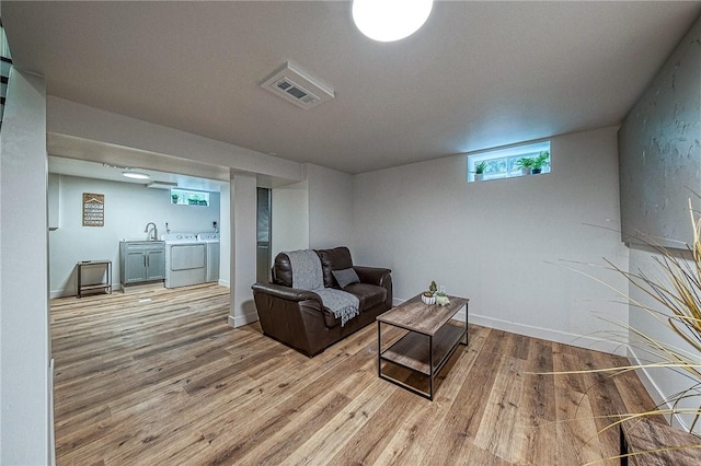 living room featuring light hardwood / wood-style flooring and washing machine and clothes dryer