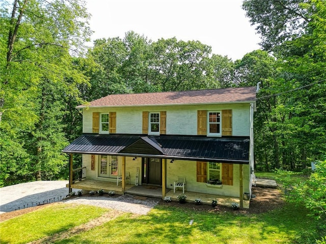 view of front of property with a porch and a front lawn