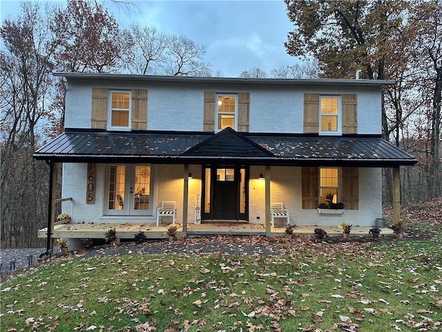 modern farmhouse featuring a front lawn and covered porch