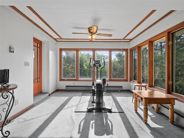 exercise area with baseboard heating, light colored carpet, ornamental molding, and ceiling fan