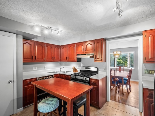 kitchen featuring sink, rail lighting, stainless steel gas range oven, light tile patterned flooring, and dishwasher