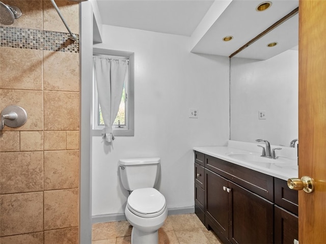 bathroom featuring vanity, tile patterned flooring, and toilet