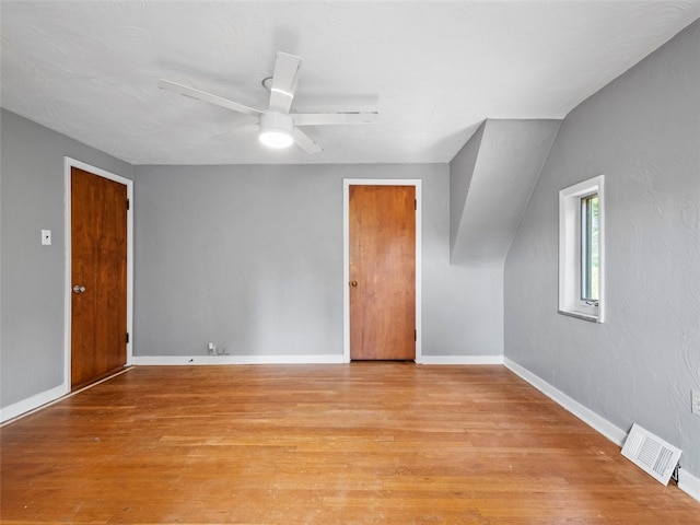 unfurnished room with light hardwood / wood-style flooring, lofted ceiling, and ceiling fan