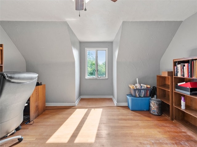 office space with ceiling fan, a textured ceiling, light hardwood / wood-style flooring, and lofted ceiling