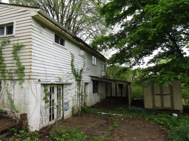 view of home's exterior with a storage unit