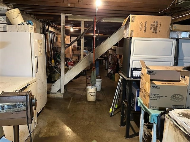 basement featuring white fridge