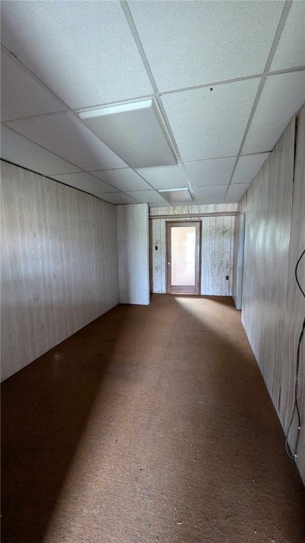 carpeted empty room with a paneled ceiling