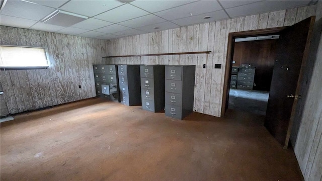 interior space with mail boxes, wood walls, and a drop ceiling