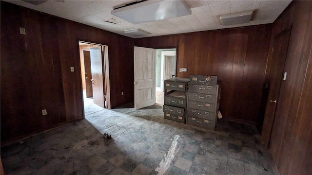 unfurnished bedroom with wood walls