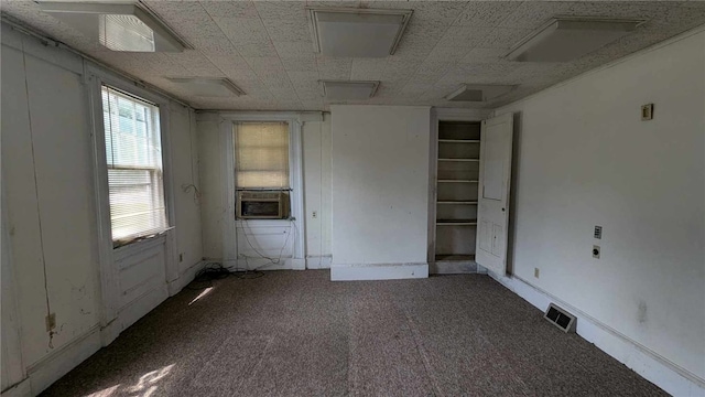 spare room featuring cooling unit and carpet flooring