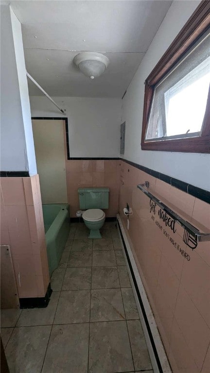 bathroom featuring tile walls, toilet, and tile patterned floors