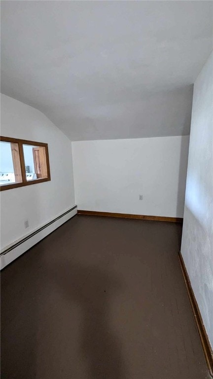 bonus room with baseboard heating and vaulted ceiling