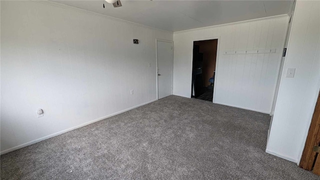 unfurnished bedroom with dark colored carpet and ornamental molding