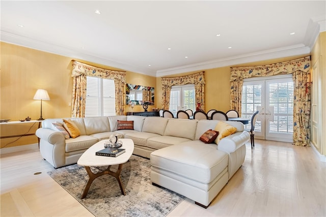 living room with crown molding and light wood-type flooring