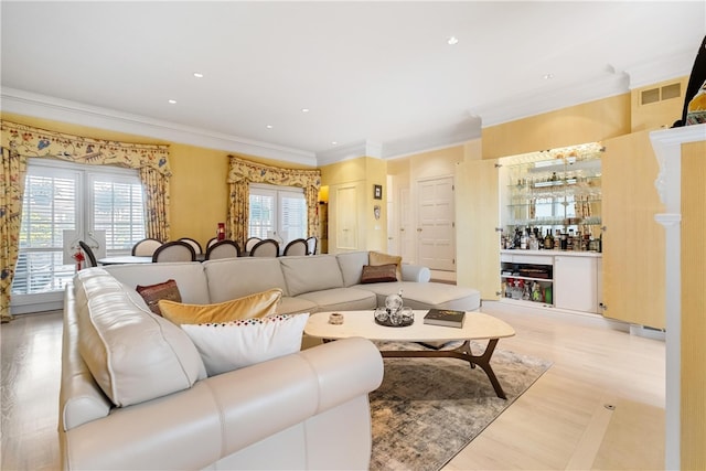 living room featuring light hardwood / wood-style floors and ornamental molding