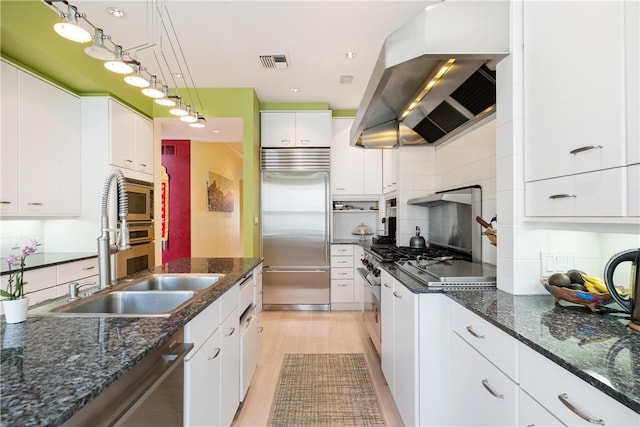 kitchen featuring island exhaust hood, white cabinets, tasteful backsplash, and stainless steel appliances