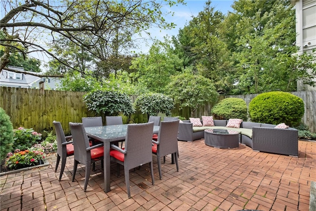 view of patio / terrace featuring an outdoor living space with a fire pit