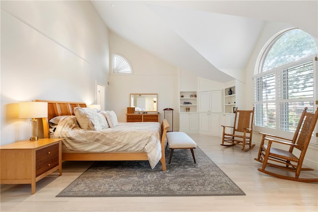 bedroom featuring light hardwood / wood-style flooring and high vaulted ceiling