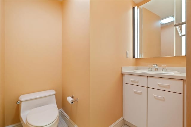 bathroom with vanity, toilet, and tile patterned floors