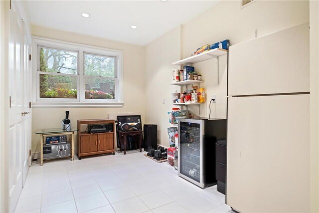 home office with light tile patterned flooring and beverage cooler