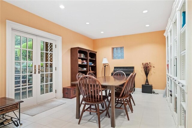 dining room featuring light tile patterned flooring and french doors