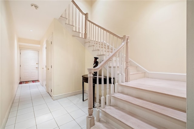 stairs with light tile patterned floors