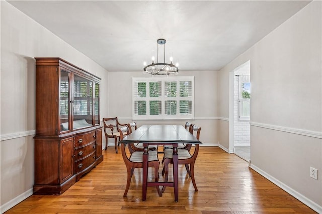 dining area featuring a notable chandelier and light hardwood / wood-style flooring