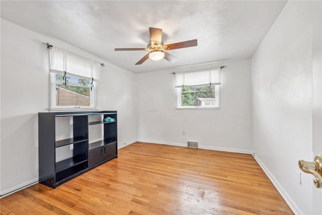 spare room with hardwood / wood-style flooring and ceiling fan