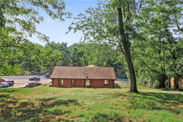 rear view of house featuring a lawn