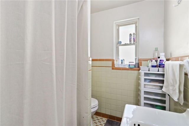 bathroom featuring decorative backsplash, tile walls, and vanity