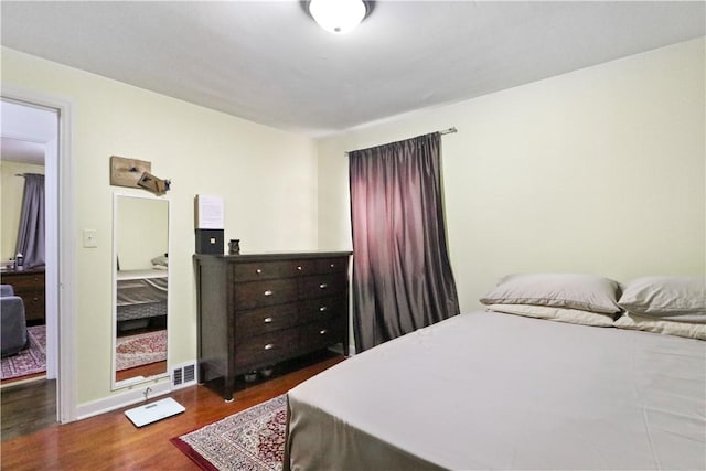 bedroom featuring dark wood-type flooring