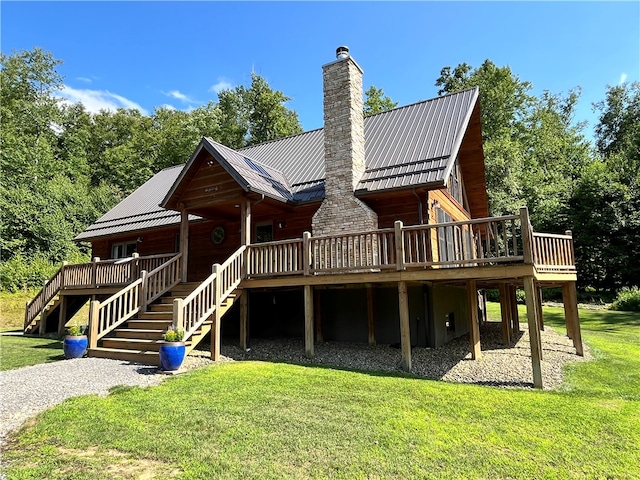 rear view of house with a deck and a lawn