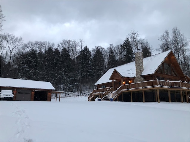 view of snow covered exterior with a wooden deck