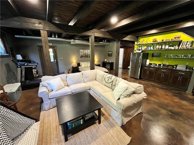 interior space featuring beam ceiling and concrete flooring