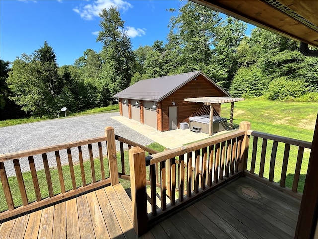 wooden terrace with a garage, an outbuilding, and a lawn