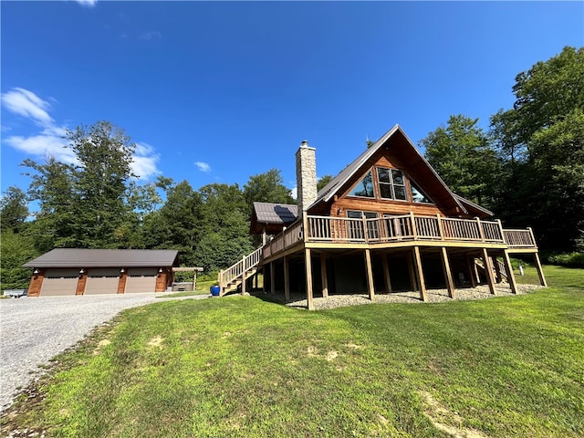 exterior space with a deck, a garage, and a lawn