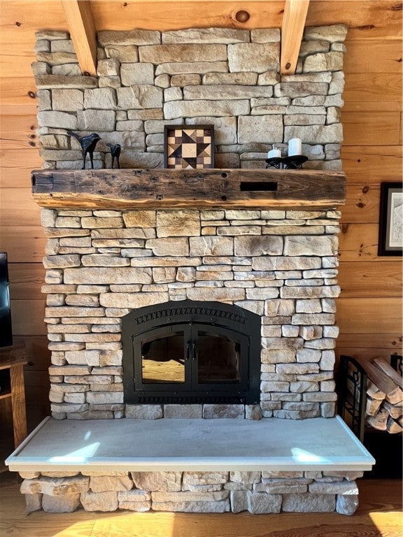 details with wooden walls, beamed ceiling, and hardwood / wood-style floors