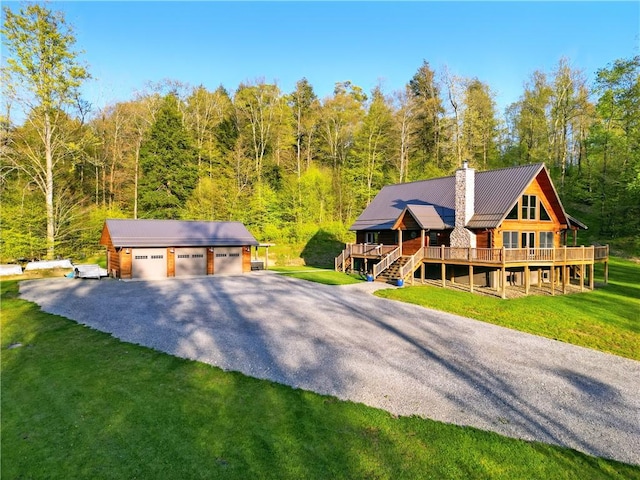 500 Seneca Hemlock Rd, Rockland Twp, PA 16374 - log-style house featuring a detached garage, a wooded view, a chimney, a deck, and an outbuilding